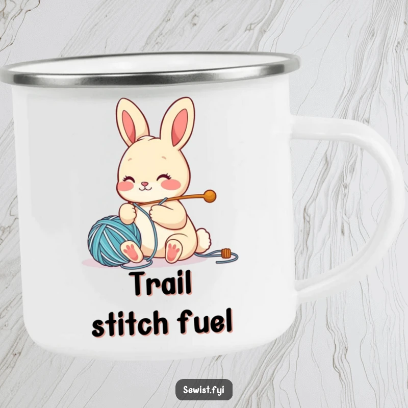 Funny Camping Mug showing a cute bunny character threading a large needle with yarn, perfect for outdoor crafting enthusiasts.