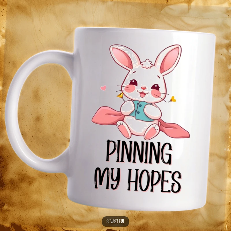 Funny Bunny Mug: A playful bunny carefully pinning fabric pieces together with a smile, celebrating crafting, perfect gift.
