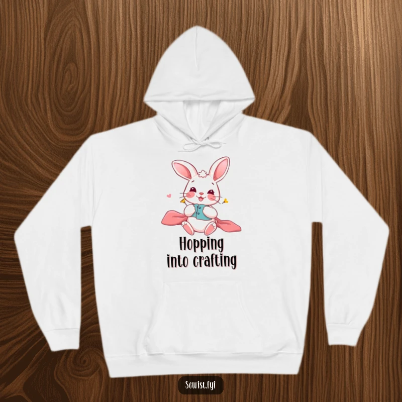 Funny Bunny Hoodie: Comfortable hoodie with a playful bunny carefully pinning fabric, embodying crafting precision, gift.