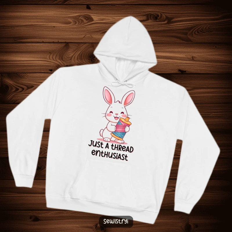 Funny Rabbit Hoodie: Warm hoodie showcasing a cheerful rabbit holding a vibrant spool of thread, perfect for crafters.